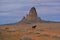 Dark horse grazing in a remote area, native american scenery with red rock formations and melancholic sky