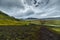 Dark Iceland landscape with green moss and black road, Iceland