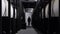 Dark interior inside chemical waste processing plant. Media. Rear view of a man walking going down the corridor near