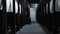 Dark interior inside chemical waste processing plant. Media. Rear view of a man walking going down the corridor near