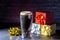 A dark Irish dry stout beer glass with a gift boxes