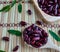 Dark Kidney bean or red beans on a tray and wooden spoon Background is a wooden mat