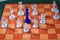 Dark King is surrounded by white pieces of chess on chess board