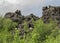 Dark lava rock formations area and green Icelandic forest in Myvatn area, Northern Iceland, Europe.