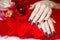 Dark manicure and flowers on red