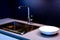 Dark marble wash basin with glossy metal mixer. Colored backlight. White plates