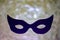 Dark mask on silver bokeh background. Mystic. Mardi Gras Concept