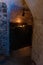 Dark medieval wine cellar. Bottles stacked by the wall