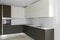 Dark minimal kitchen in a modern apartment