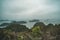 A dark and misty overcast morning on Halong Bay, toned photo. Beautiful mountain landscape with the viewpoint on the island of Cat