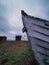 Dark mood with shipwreck in the foreground and old Sweden houses in front of the water in the background