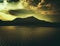 A dark moody beautiful picture of a lake, water hill and sunset sky