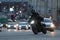 Dark motorcyclist passing the road turn against road on background