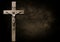 Dark mottled brown and black tones with body of Christ on wooden cross