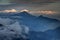 Dark mountains, autumn mist and sunlit clouds in Slovenian Alps