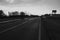 Dark mysterious landscape with a road crossing the countryside