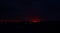 Dark Obscurity: Somber Sunset\\\'s Red Glow Over Black Mountains, Hills Touching the Horizon