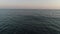 Dark open sea in the evening at sunset, aerial view. Beautiful marine background