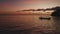 Dark peaceful aerial footage of ocean bay with silhouettes of fishing boats at sunset. Fishery vehicles and motorboats