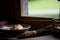 Dark picture of light flowing in on Bread and Pear in bowl by the window sill