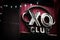 Dark pink electric nightclub sign lettering: xo club. Nightlife in a strip club