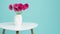 Dark pink gerberas in a vase on a retro table. Happy Mother`s Day, Women`s Day, Valentine`s Day or Birthday background.