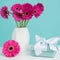 Dark pink gerberas in a vase on a table with beautiful present. Happy Mother`s Da concept.