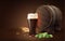 Dark porter beer in glass cup and wood barrel with wheat and hops, refreshing drink with white foam in 3d illustration