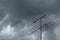 Dark powerful storm clouds before rain against old television antenna on the roof.