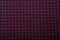 Dark purple and black checkboard pattern shirt fabric background, garment texture