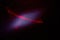 On a dark purple fine-grained background, a light purple cloud of light and a red laser beam