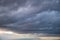 Dark rain clouds in the evening sky. Dramatic sky with an coming cloud