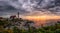 Dark rain clouds and a rising sun at Portland Head Lighthouse