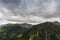 dark rainclouds over mountains and trees