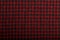 Dark red and black checkboard pattern shirt fabric background, garment texture