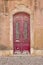 Dark red door in ancient portuguese faro