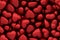 Dark red glossy hearts as background