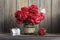 Dark red peonies in a decorated glass jar