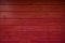 Dark Red wooden wall as background. Red texture. Wooden red fence. Red planks.