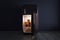 Dark refrigerator secret - shining gold and golden coins stack inside retro fridge in an dark empty room