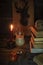 Dark retro rustic still life, with old books, tea with milk and cinnamon, apple by candlelight