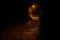 Dark road at night iluminated by a single streetlight