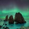 Dark rock against northern lights landscape with stars, starry sky with polar lights. Beautiful massive northern lights