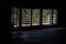 Dark room with sports mats overlooking a veranda with wooden fence.