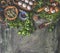 Dark rustic food background. Herbs and seasoning with wooden vintage kitchen utensils and ingredients. Top view. Copy space. Flat