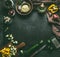Dark rustic food background with vegetables and herbs on dark rustic kitchen table background with ingredients and utensils, top