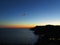 Dark scenic coastline by astronomical twilight with glowing horizon