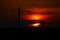 Dark scenic sunset behind a telecommunications tower