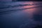 Dark sea sandy beach and red sunlight sunset twilight ocean