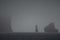 Dark see with huge icebergs in it covered by a thick gloomy mist in Antarctica